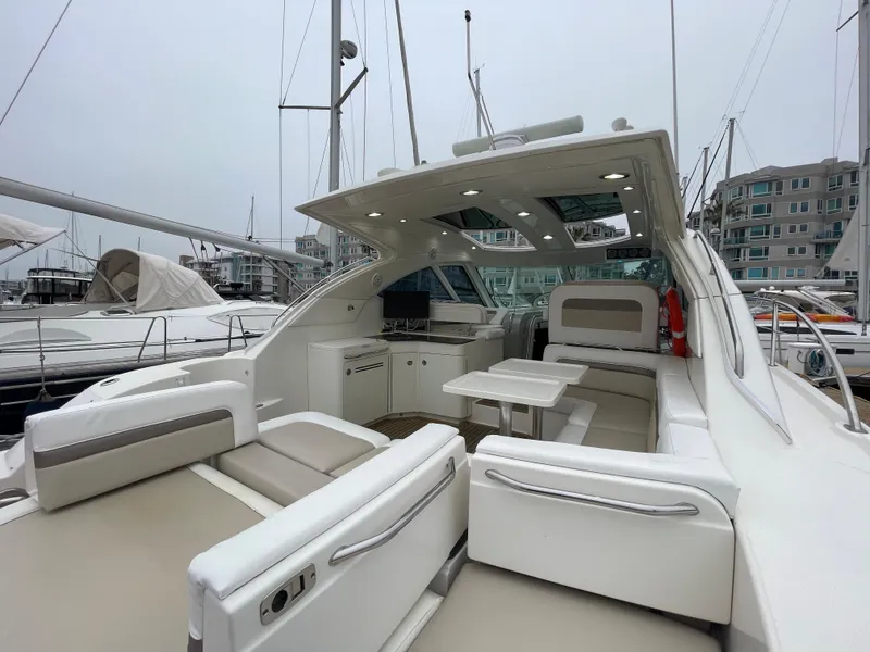 Slide: The Image of The image shows the cockpit of a 2012 Sea Ray 470 Sundancer with sleek seating and a table. - 15