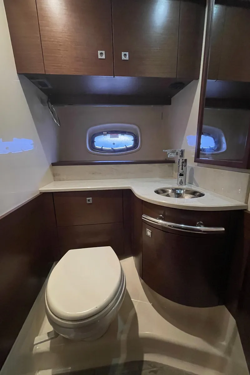 Slide: The Image of The image shows an elegant bathroom on a 2012 Sea Ray 470 Sundancer with modern fixtures. - 37