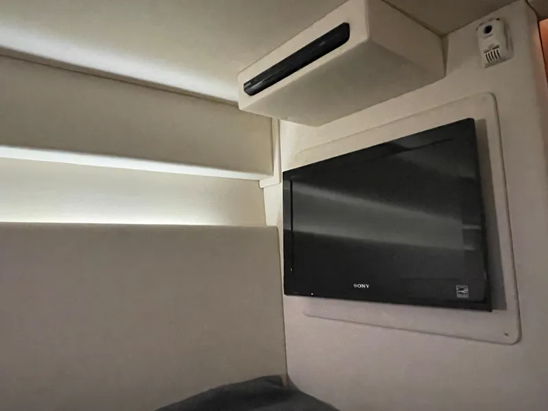 Slide: The Image of Interior of a Sea Ray 470 Sundancer featuring a Sony TV mounted on the wall. - 42
