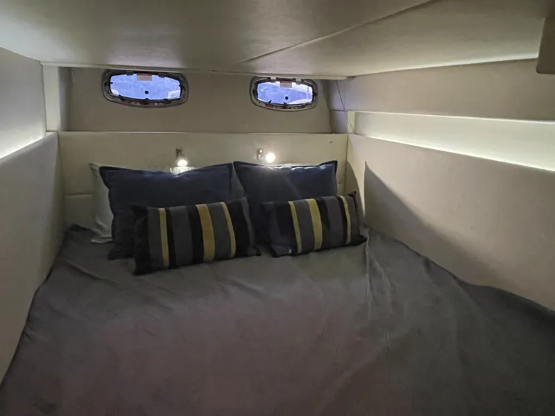 Slide: The Image of The image shows a cozy cabin with a double bed and two windows on the wall. - 41