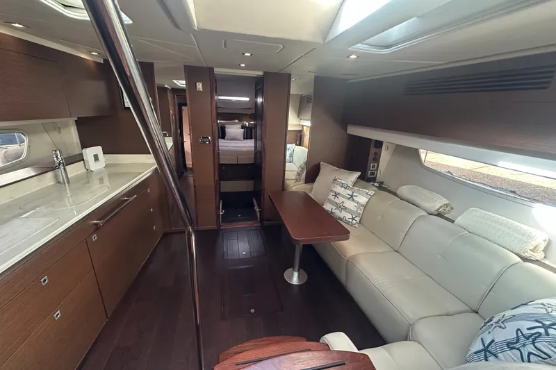 Slide: The Image of Luxurious interior of 2012 Sea Ray 470 Sundancer yacht with modern kitchen and cozy seating area. - 27