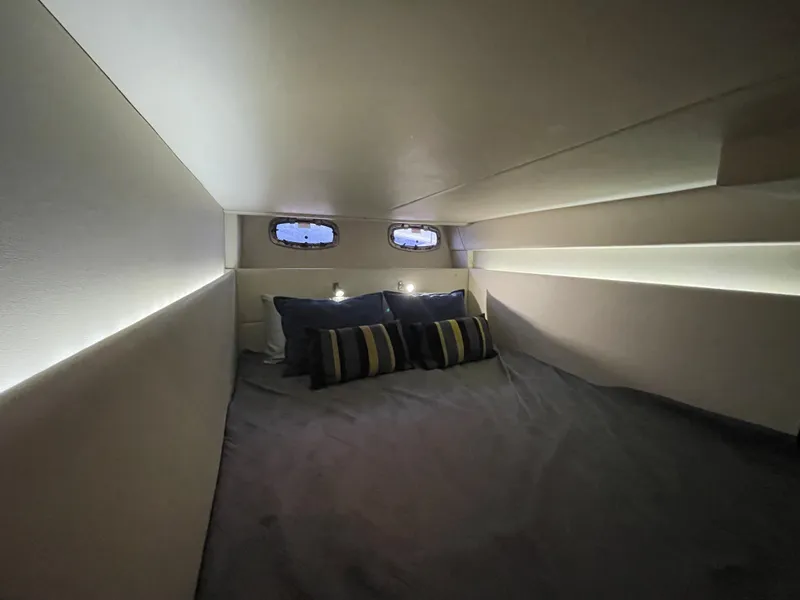 Slide: The Image of The image shows a cozy cabin with a large bed and small windows. - 40