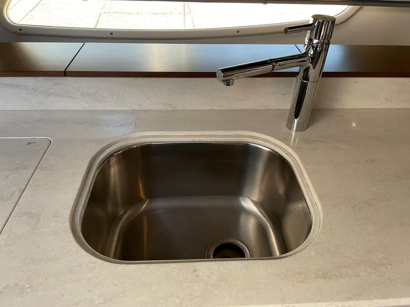 Slide: The Image of A stainless steel sink with a modern faucet on a sleek countertop. - 34