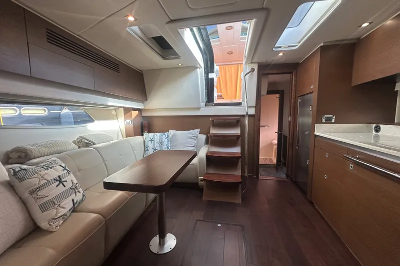 Slide: The Image of Luxurious interior of a 2012 Sea Ray 470 Sundancer yacht with elegant seating and modern amenities. - 29