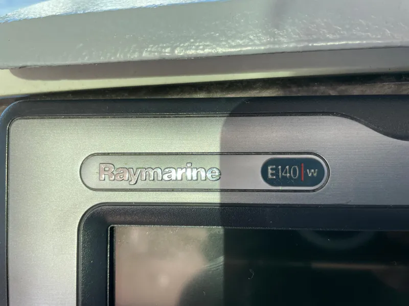 Slide: The Image of Close-up of a Raymarine E140w navigation system on a boat. - 21