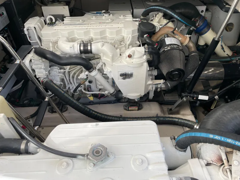 Slide: The Image of The engine room of a 2012 Sea Ray 470 Sundancer features a clean, white engine. - 49