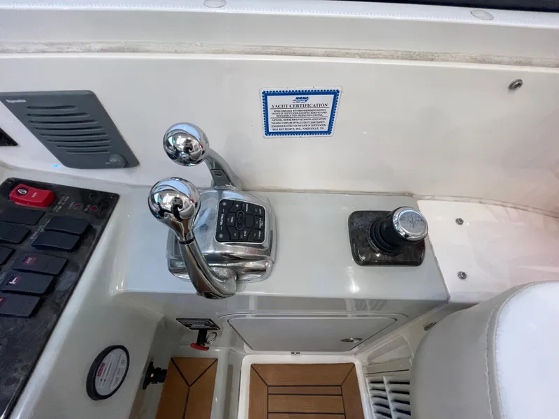 Slide: The Image of The image shows the helm of a 2012 Sea Ray 470 Sundancer with throttle levers and controls. - 23