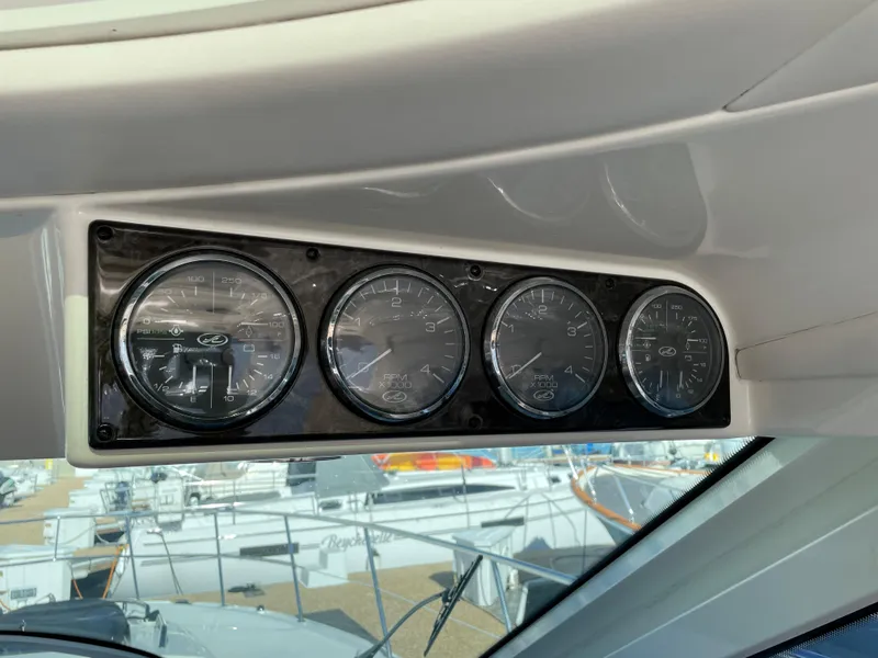 Slide: The Image of The image shows a dashboard with four analog gauges on a Sea Ray 470 Sundancer boat. - 22