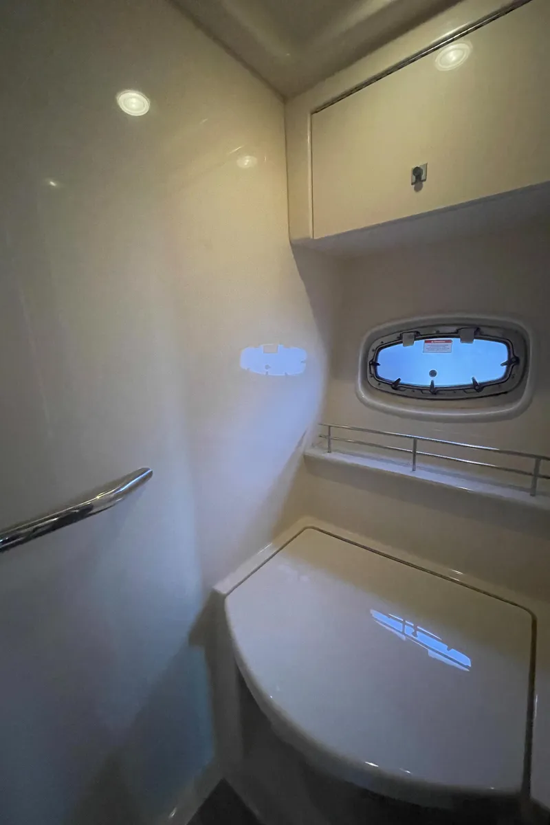 Slide: The Image of The image shows a sleek bathroom on a 2012 Sea Ray 470 Sundancer. - 44