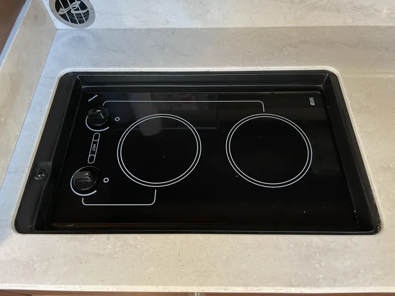 Slide: The Image of A built-in cooktop with two burners and control knobs on a countertop. - 33