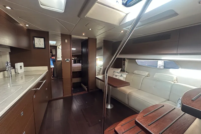 Slide: The Image of Luxurious interior of 2012 Sea Ray 470 Sundancer yacht with modern kitchen and seating area. - 28