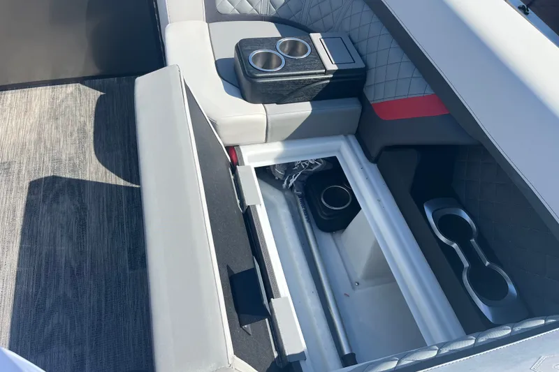 Slide: The Image of Interior view of 2022 Godfrey AquaPatio 235 ULC boat with open storage compartment. - 14