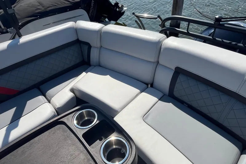 Slide: The Image of Luxurious seating on 2022 Godfrey AquaPatio 235 ULC pontoon boat with cup holders. - 10