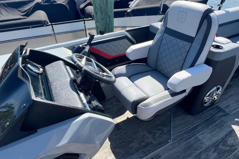 Slide: The Image of Luxurious helm seat and steering console of 2022 Godfrey AquaPatio 235 ULC pontoon boat. - 5