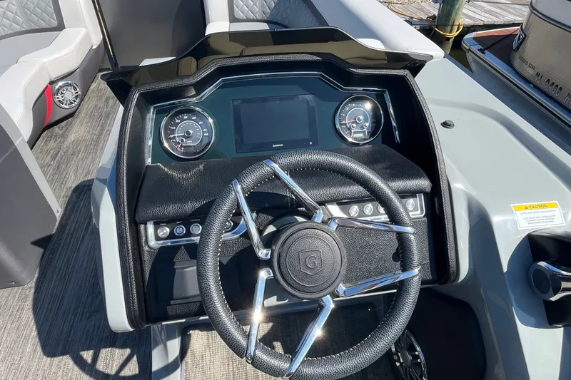 Slide: The Image of Cockpit of 2022 Godfrey AquaPatio 235 ULC with modern steering and dashboard controls. - 8