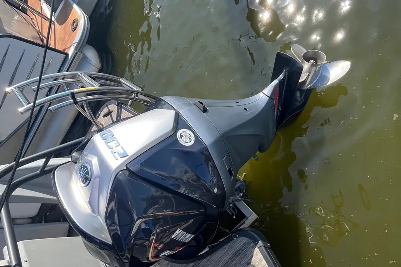 Slide: The Image of Outboard motor on 2022 Godfrey AquaPatio 235 ULC pontoon boat in water. - 16