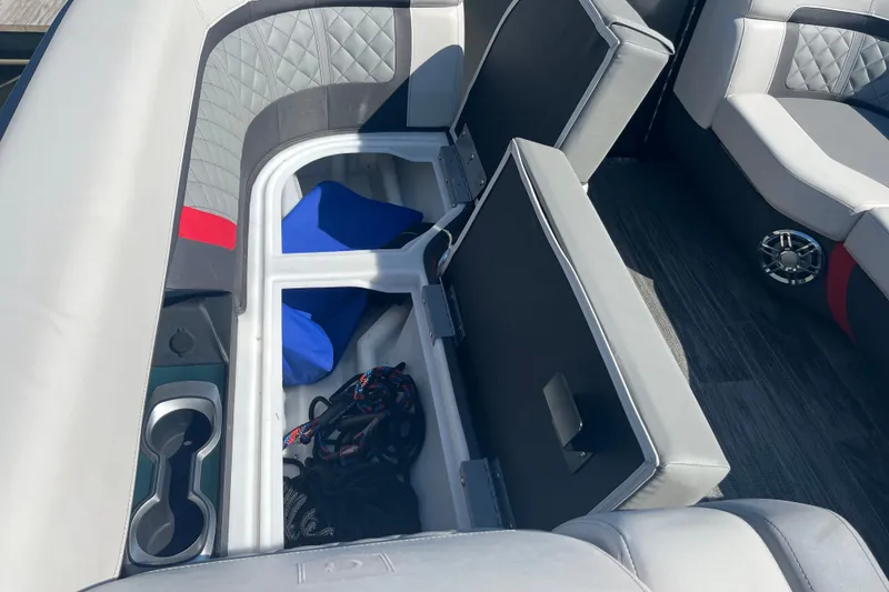 Slide: The Image of 2022 Godfrey AquaPatio 235 ULC boat interior with open storage compartment and seating. - 12