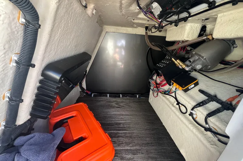 Slide: The Image of Interior view of 2022 Godfrey AquaPatio 235 ULC boat showing wiring and equipment. - 18