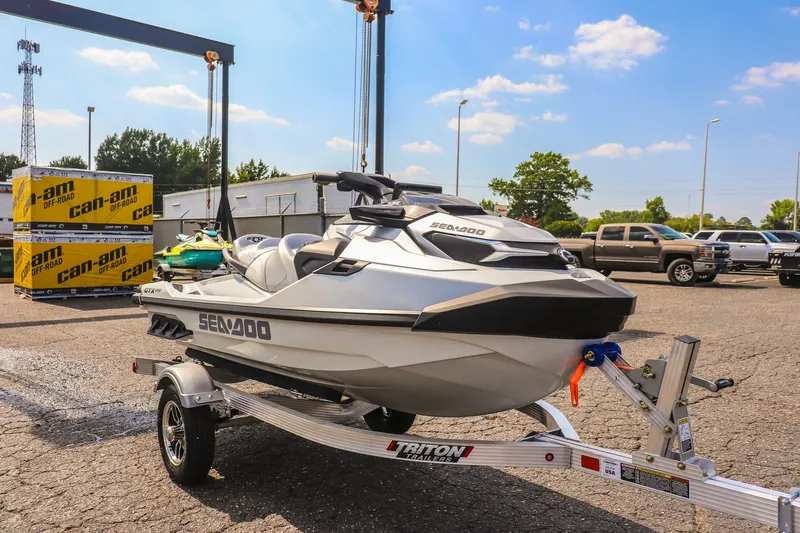 The Image of 2025 Sea-Doo GTX Limited 325 on trailer in parking lot, sunny day. - 1