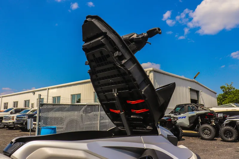 Slide: The Image of 2025 Sea-Doo GTX Limited 325 with open storage compartment, parked outdoors under blue sky. - 14