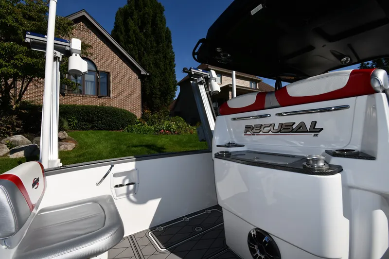 Slide: The Image of 2017 Sunsation 32 CCX boat interior with seating and equipment, near a brick house. - 16