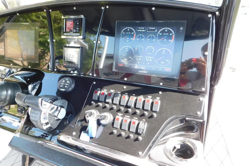 Slide: The Image of Control panel of a 2017 Sunsation 32 CCX boat with Garmin display and switches. - 30