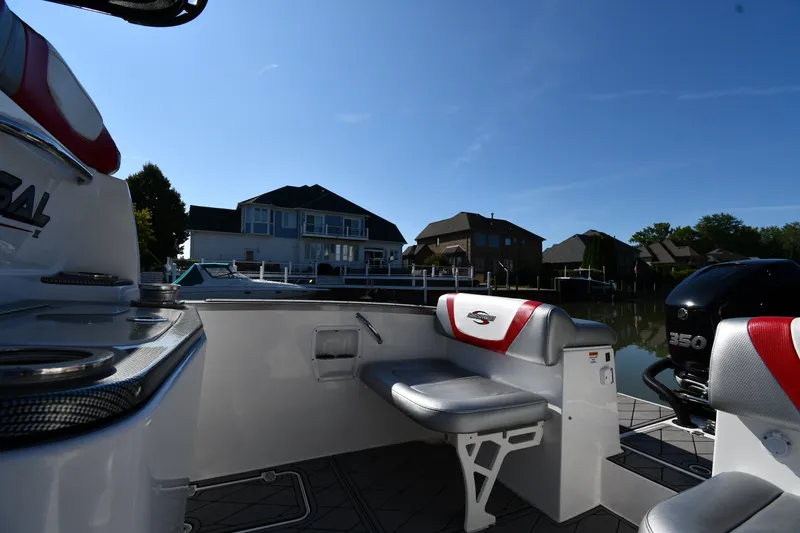 Slide: The Image of 2017 Sunsation 32 CCX boat interior with seating, docked near waterfront homes. - 18