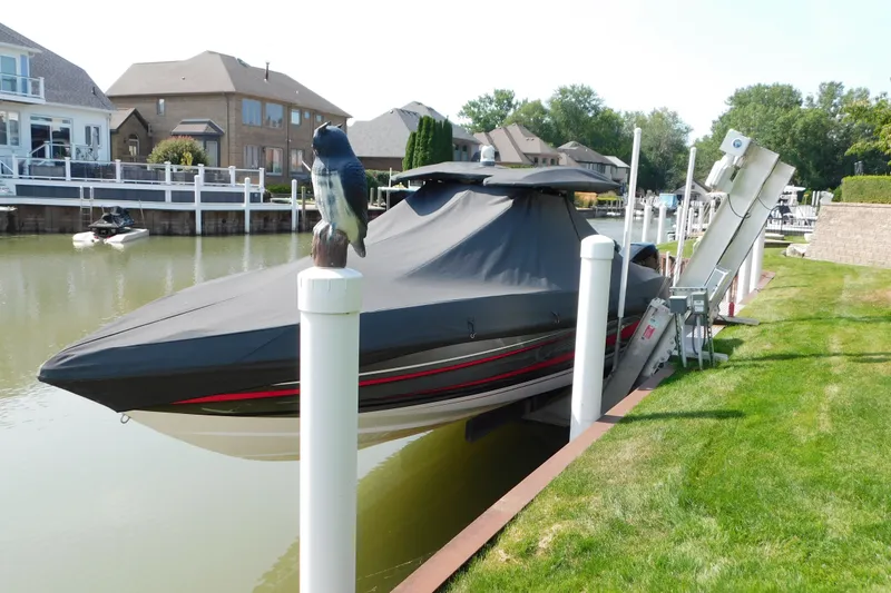 Slide: The Image of 2017 Sunsation 32 CCX boat covered and docked in a residential canal setting. - 53