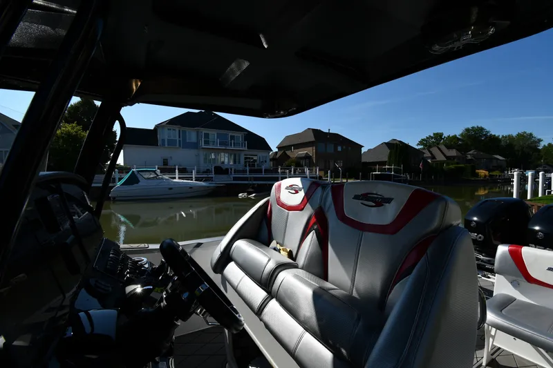 Slide: The Image of 2017 Sunsation 32 CCX boat interior with luxurious seating, docked near waterfront homes. - 14