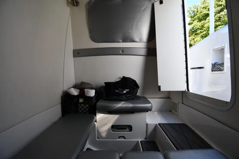 Slide: The Image of Interior cabin of 2017 Sunsation 32 CCX boat, featuring seating and storage space. - 34