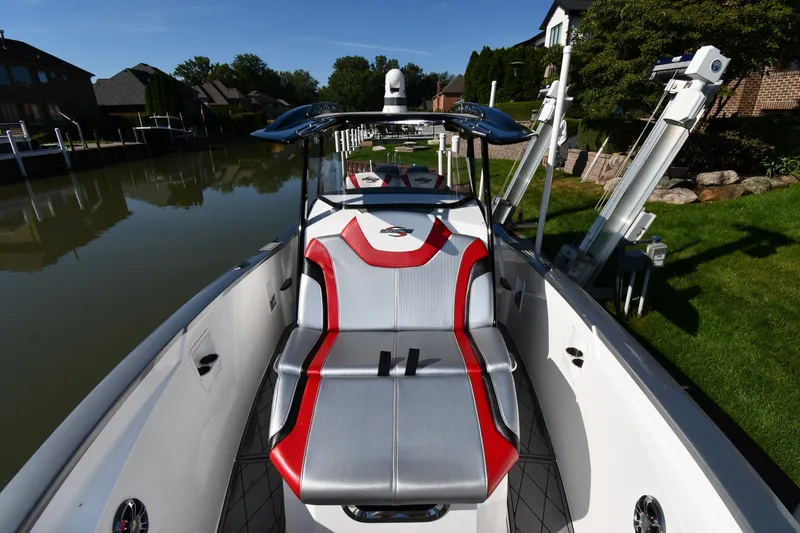 Slide: The Image of 2017 Sunsation 32 CCX boat docked by a canal, featuring sleek seating and modern design. - 9