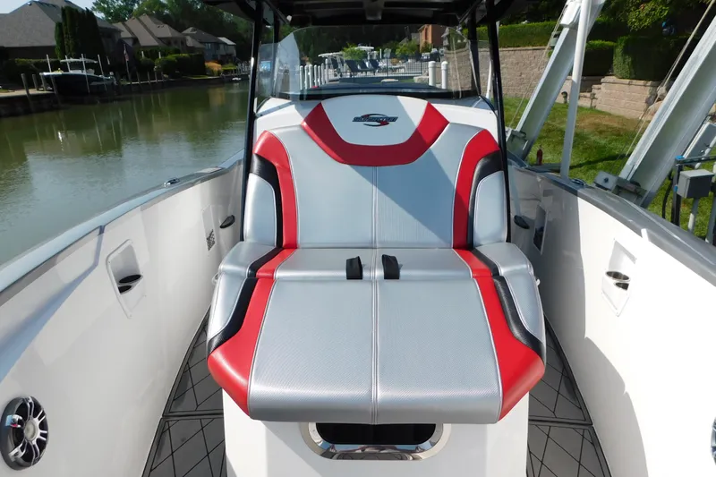 Slide: The Image of 2017 Sunsation 32 CCX boat interior with red and gray seating, docked by a canal. - 23