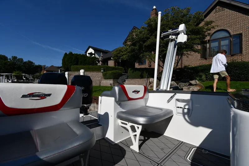 Slide: The Image of 2017 Sunsation 32 CCX boat interior with seating, docked near waterfront homes. - 17