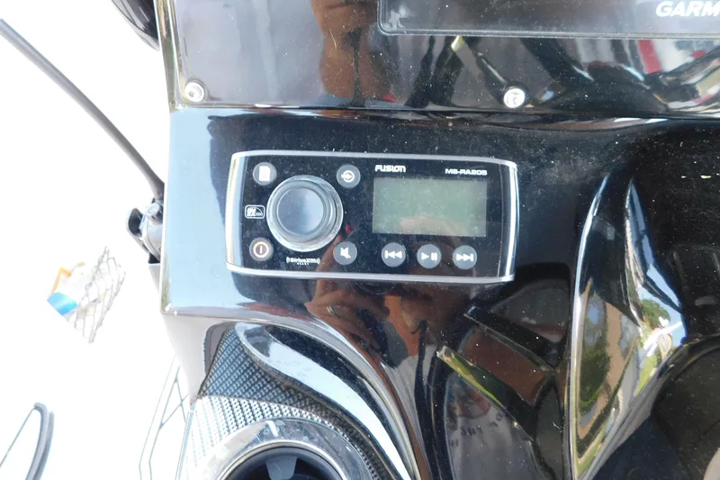 Slide: The Image of Control panel of a 2017 Sunsation 32 CCX boat featuring a Fusion audio system. - 34