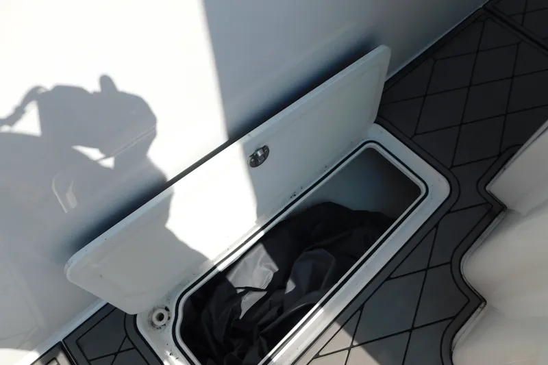 Slide: The Image of Open storage compartment on 2017 Sunsation 32 CCX boat with shadow and interior view. - 40