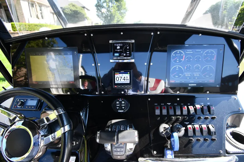 Slide: The Image of Dashboard of a 2017 Sunsation 32 CCX boat with navigation and control panels. - 13