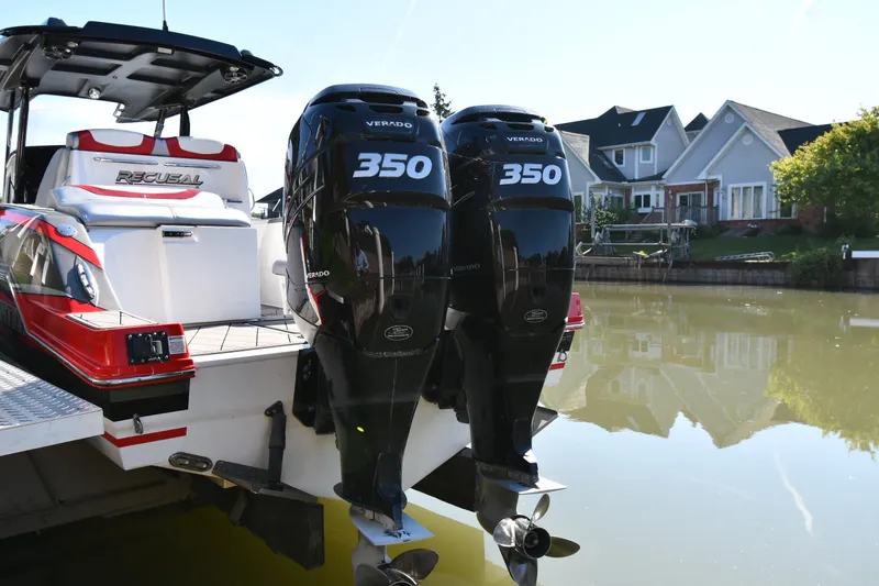 Slide: The Image of 2017 Sunsation 32 CCX boat with twin Verado 350 engines docked by waterfront homes. - 4