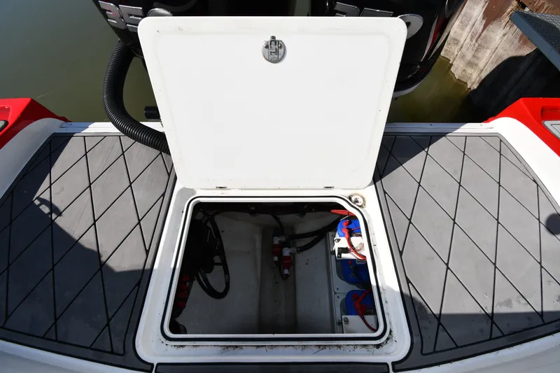 Slide: The Image of Open hatch on 2017 Sunsation 32 CCX boat, revealing storage compartment. - 28