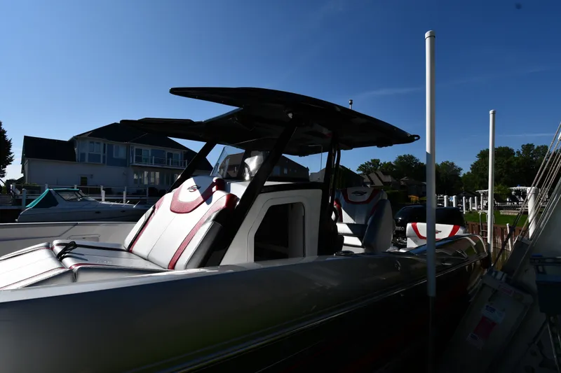 Slide: The Image of 2017 Sunsation 32 CCX boat docked under clear blue sky. - 2