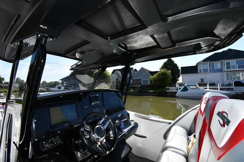 Slide: The Image of Interior view of 2017 Sunsation 32 CCX boat with modern dashboard and luxurious seating. - 12