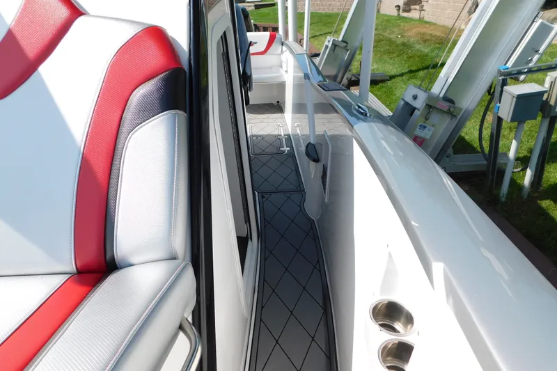 Slide: The Image of 2017 Sunsation 32 CCX boat interior with red and white seating and sleek deck design. - 24