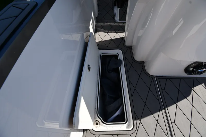 Slide: The Image of Storage compartment on 2017 Sunsation 32 CCX boat with sleek deck design. - 26