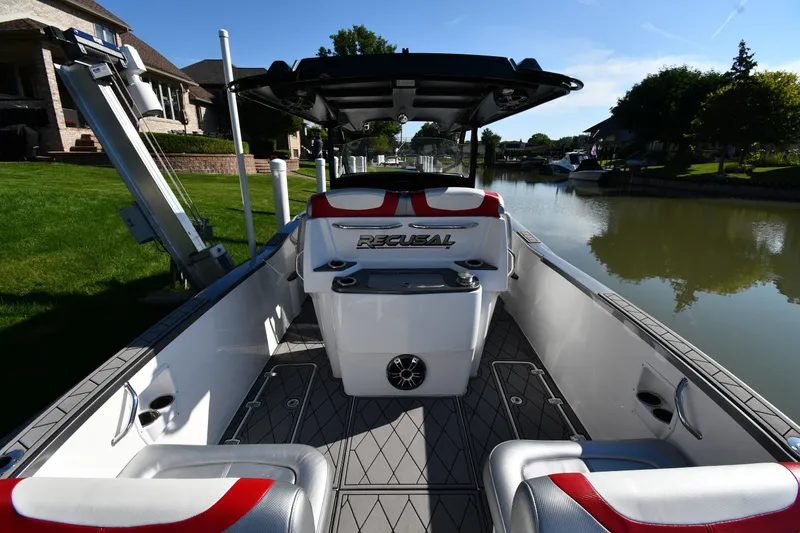 Slide: The Image of 2017 Sunsation 32 CCX boat interior with sleek seating and modern design on a calm waterway. - 10