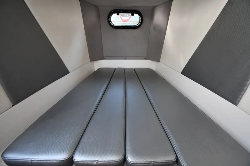 Slide: The Image of 2017 Sunsation 32 CCX cabin interior with gray cushioned seating and small window. - 33
