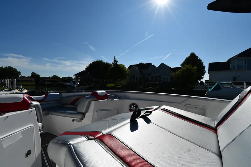 Slide: The Image of 2017 Sunsation 32 CCX boat interior with red and white seating under bright sun. - 20