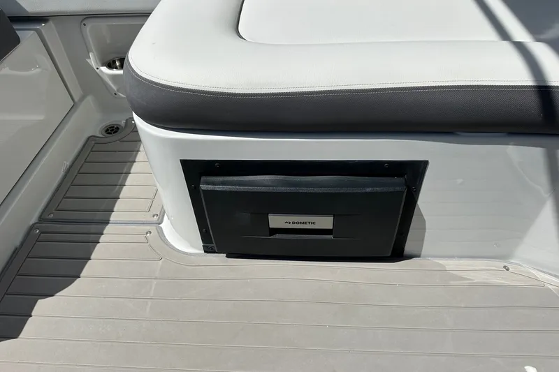 Slide: The Image of 2021 Crownline Eclipse E305 XS boat interior with Dometic cooler under seat. - 15