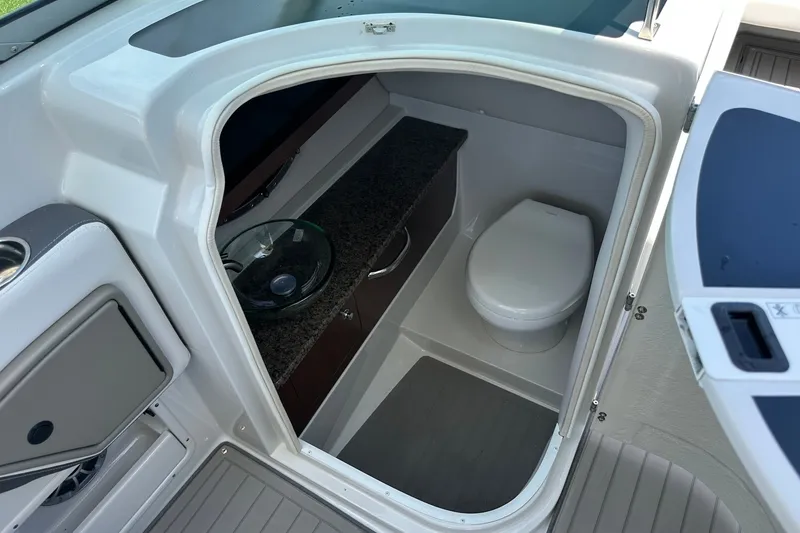 Slide: The Image of 2021 Crownline Eclipse E305 XS boat interior with compact bathroom and modern amenities. - 27