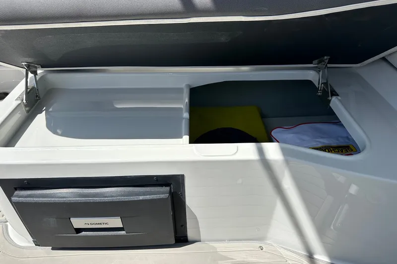Slide: The Image of Storage compartment of 2021 Crownline Eclipse E305 XS boat with Dometic cooler. - 14