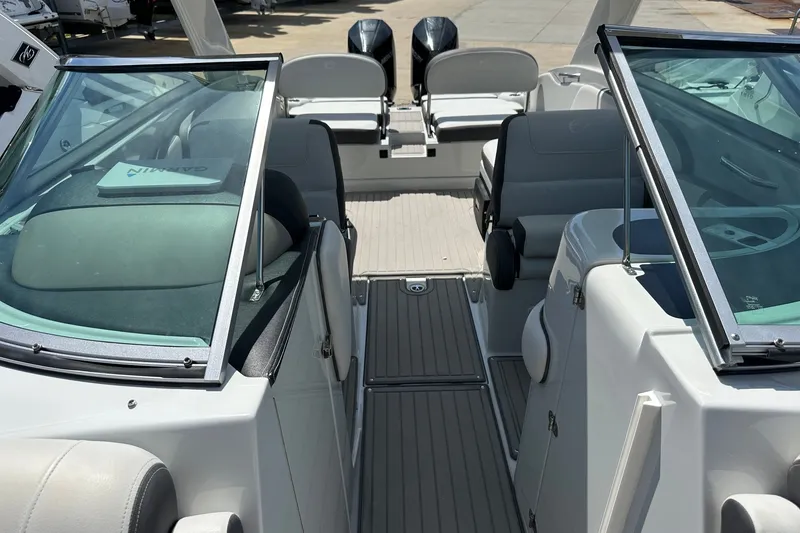 Slide: The Image of 2021 Crownline Eclipse E305 XS boat interior with seating and dual windshields. - 30