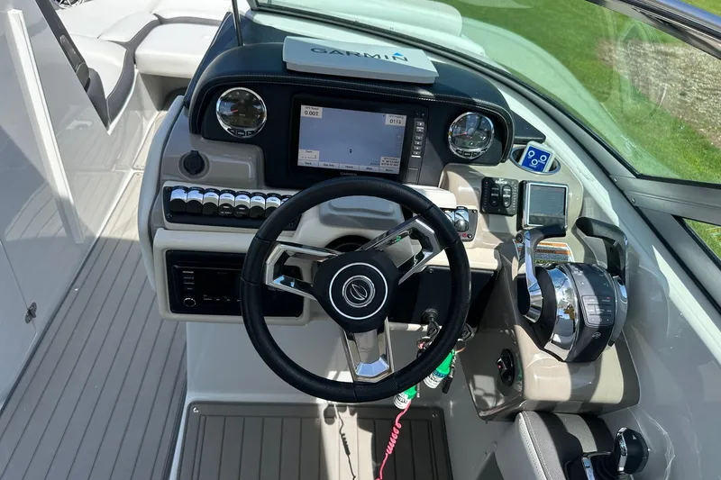 Slide: The Image of Cockpit of 2021 Crownline Eclipse E305 XS with Garmin navigation system and modern controls. - 24